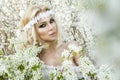 Stunning blonde natural woman swing on a swing on a tree wearing a spring dress Royalty Free Stock Photo