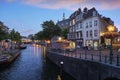 Stunning blue hour image of the historic city center of Leiden with new canal and Koorn bridge at sunset