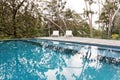 Stunning blue tiled infinity swimming pool in Australian bush se Royalty Free Stock Photo