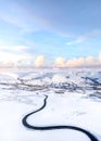 Stunning blue winter snow pink clouds sky winding icy black road in mountains no people dramatic sky snowy landscape near Mam Tor Royalty Free Stock Photo