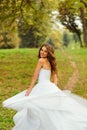 Stunning bride looks over her shoulder while whirling
