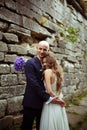 Stunning bride smiles being hugged by a groom