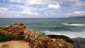 Stunning bright panoramic views of the Cretan sea from the city of Chania, with part of the ruined old walls in the foreground.