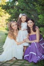 Stunning Brunette blond chestnut blue eyes sisters girls wearing stylish white purple dress enjoying life time together summer sun