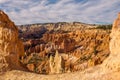 The stunning Bryce Canyon in all its glory taken from between two sandstone hoodoos with more amazing hoodoos in the distance with