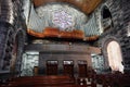 Stunning church interior, full of wooden pews and a magnificent stained glass window Royalty Free Stock Photo