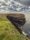 Stunning cliff in county Clare, Ireland, Loop head area. Dramatic cloudy sky. Irish landscape. Popular travel and nature Royalty Free Stock Photo