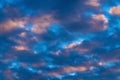 Stunning clouds in blue sky, illuminated by rays of sun at sunset to change weather. Colorful abstract meteorology Royalty Free Stock Photo