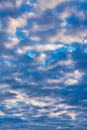 Stunning clouds in blue sky, illuminated by rays of sun at sunset to change weather. Colorful summer cloudscape Royalty Free Stock Photo