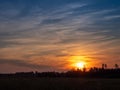 Stunning colorful sunset sky over a forest silhouette. Warm and cool color. Beautiful nature scene. Calm and relaxing mood and Royalty Free Stock Photo