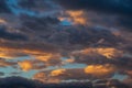 Stunning colorful thunderclouds in blue sky, illuminated by rays of sun at sunset to weather change. Abstract Royalty Free Stock Photo