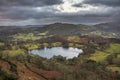 Stunning colorful Winter sunrise golden hour landscape view from Loughrigg Fell across the countryside in the Lake District Royalty Free Stock Photo