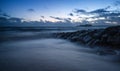 Stunning colorful Winter sunset sky above burned out pier at sea Royalty Free Stock Photo