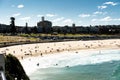 Sydney, NSW/Australia: Bondi Beach with the Iceberg Pool in the background and the surfers