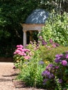 Stunning, colourful mixed perennial flower borders with pink hydrangeas at the RHS Wisley garden, Surrey UK.