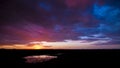 Stunning colourful surreal edited sunset at Halali waterhole, Etosha national park, Namibia