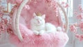 A Beautiful Girly White Kitty Cat Princess Wearing a Royal Crown on a Luxurious Fluffy Flowery Pink Floating Chair Royalty Free Stock Photo