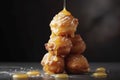 A close-up view of a tower of croquembouches, filled with creamy custard and drizzled with caramel.