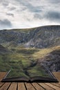 Stunning detail landscape image of mountain of Tryfan near Llyn Ogwen in Snowdonia during early Autumn coming out of pages of open Royalty Free Stock Photo