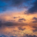 Stunning dramatic colorful stormy landscape sunset sky with lovely moody contrast in the clouds