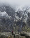 Stunning dramatic landscape image of snowcapped Glyders mountain range in Snowdonia during Winter with menacing low clouds hanging