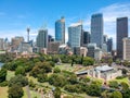 Stunning drone aerial wide angle view of the city of Sydney and its skyscrapers shot from above the Royal Botanical Gardens