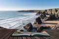 Stunning dusk sunset landscape image of Bedruthan Steps on West Cornwall coast in England coming out of pages of open story book Royalty Free Stock Photo