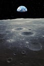 A stunning Earthrise over the moon\'s surface, as our planet emerges from the dark starry background. Copy space, vertical,