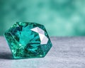 Stunning emerald green gemstone on textured surface Royalty Free Stock Photo