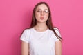 Stunning female model posing with kiss face expression on rosy round. Close up portrait of stylish european girl standing in front Royalty Free Stock Photo