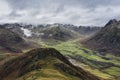 Stunning flying drone landscape image of Langdale pikes and valley in Winter with dramatic low level clouds and mist swirling Royalty Free Stock Photo