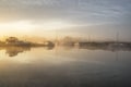 Stunning foggy Summer sunrise over peaceful river landscape in E