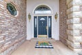 Stunning front door exterior of a house with golden fixtures