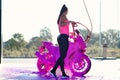 Stunning girl washes motorcycle in car wash service with high pressure water. Royalty Free Stock Photo