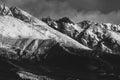 Stunning grayscale sho of snow-capped mountains in a serene winter setting Royalty Free Stock Photo