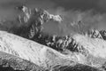 Stunning grayscale sho of snow-capped mountains in a serene winter setting Royalty Free Stock Photo