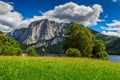 Stunning green field and alpine lake with mountains,Altaussee,Austria Royalty Free Stock Photo