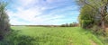 Stunning high resolution panorama of a northern german agricultural landscape on a sunny day with white cloud formations on a blue Royalty Free Stock Photo