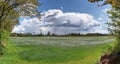 Stunning high resolution panorama of a northern german agricultural landscape on a sunny day with white cloud formations on a blue Royalty Free Stock Photo