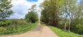 Stunning high resolution panorama of a northern german agricultural landscape on a sunny day with white cloud formations on a blue Royalty Free Stock Photo