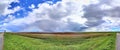 Stunning high resolution panorama of a northern german agricultural landscape on a sunny day with white cloud formations on a blue Royalty Free Stock Photo