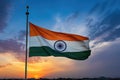 A stunning image capturing the Indian flag proudly fluttering against the clear blue sky, Tricolor Indian flag during sunset and a Royalty Free Stock Photo