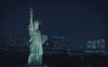 the statue of liberty is illuminated at night by lights from behind it