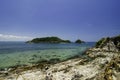 Stunning image rocky beach surrounded by clear blue sea water at Kapas Island, Malaysia. Royalty Free Stock Photo