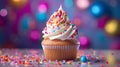 Cupcake with a kaleidoscope of sprinkles and icing on top Royalty Free Stock Photo