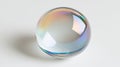 Iridescent Sphere Rests on White Surface in Studio Lighting Royalty Free Stock Photo