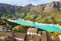 A stunning lake in Spain with a gentle blue water hid between mountains with small towns