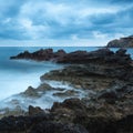 Stunning landscape dawn sunrise with rocky coastline and long ex Royalty Free Stock Photo