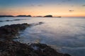 Stunning landscape dawn sunrise with rocky coastline and long exp Royalty Free Stock Photo