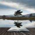 Stunning landscape image of dramatic storm clouds over Kelly Hall Tarn in Lake District during late Autumn Fall afternoon coming Royalty Free Stock Photo